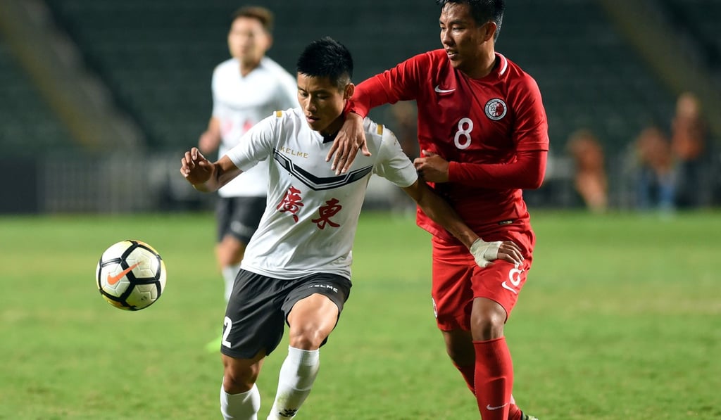 Hong Kong’s Tam Lok-hin (right) and Guangdong’s Xiao Zhi battle for the ball.