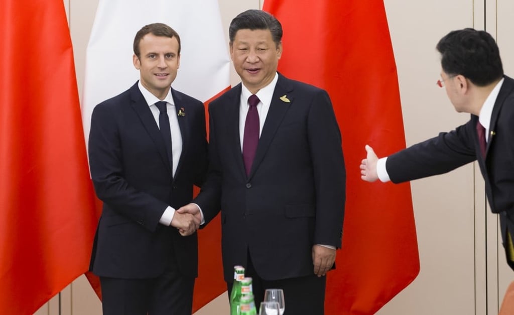 Chinese President Xi Jinping (right) shakes hands with French President Emmanuel Macron before their meeting on the sidelines of the G20 summit in the German city of Hamburg in July 2017. Photo: AFP