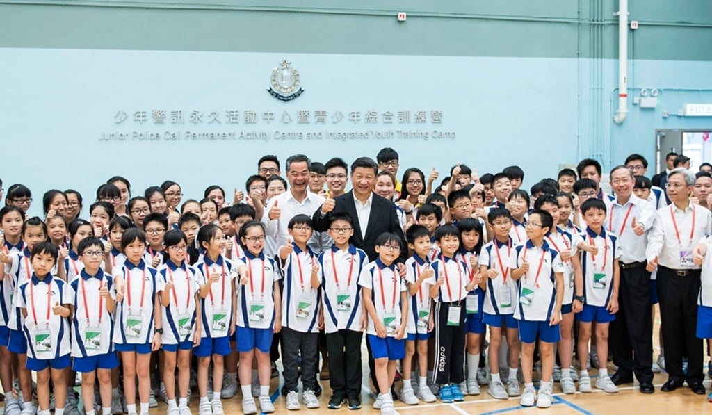 Xi (centre) with then Hong Kong leader Leung Chun-ying (left) at the Junior Police Call training school in Pat Heung. Photo: Xinhua Xi (centre) with then Hong Kong leader Leung Chun-ying (left) at the Junior Police Call training school in Pat Heung. Photo: Xinhua
