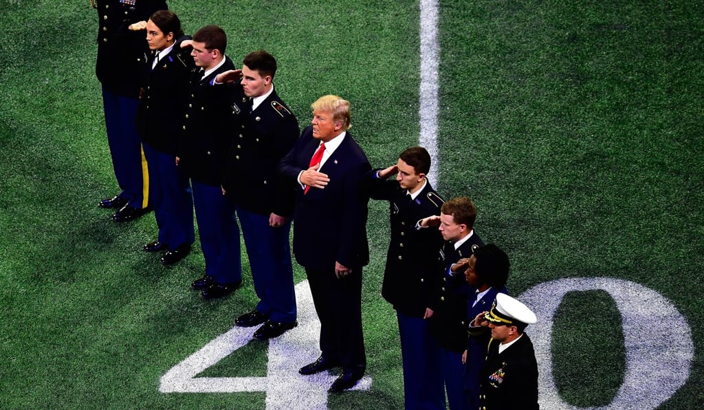 US President Donald Trump on field during the national anthem in Atlanta, Georgia. Photo: Agence France-Presse