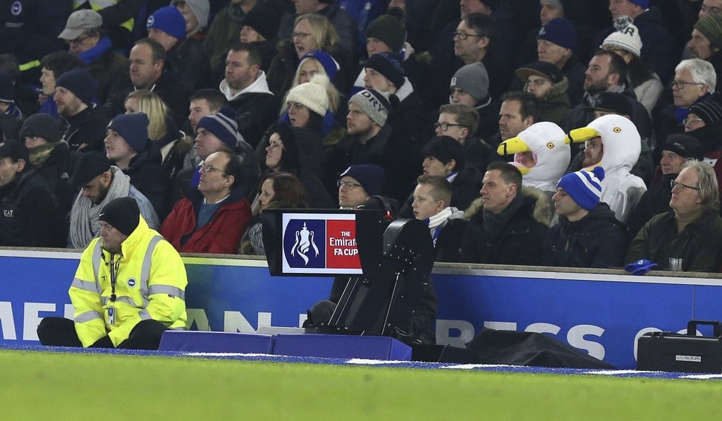 Fans watch the action as new technology also watches, with the pitchside Video Assistant Referee (VAR) system being used for first time. Photo: AP Fans watch the action as new technology also watches, with the pitchside Video Assistant Referee (VAR) system being used for first time. Photo: AP