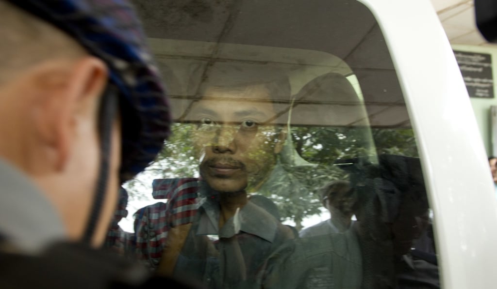 Reuters journalist Kyaw Soe Oo looks out from a police van as he arrives at a Yangon court. Photo: AP Reuters journalist Kyaw Soe Oo looks out from a police van as he arrives at a Yangon court. Photo: AP