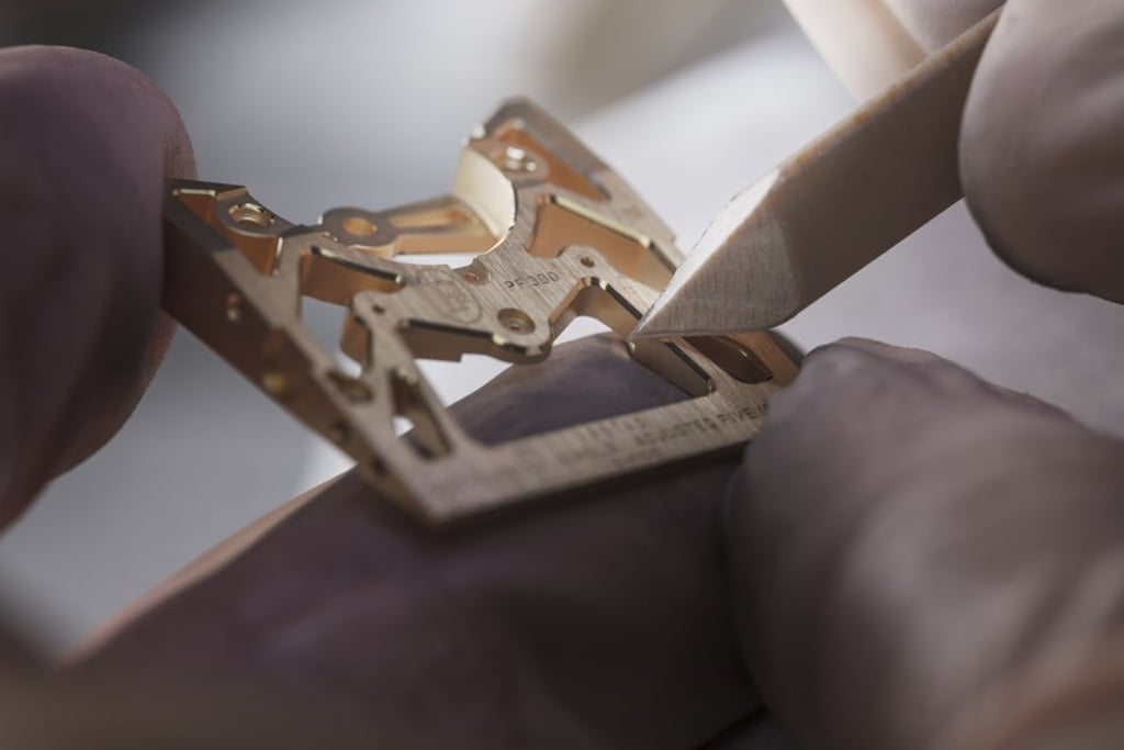 A watch maker working on a part from the Parmigiani x Bugatti timepiece. A watch maker working on a part from the Parmigiani x Bugatti timepiece.