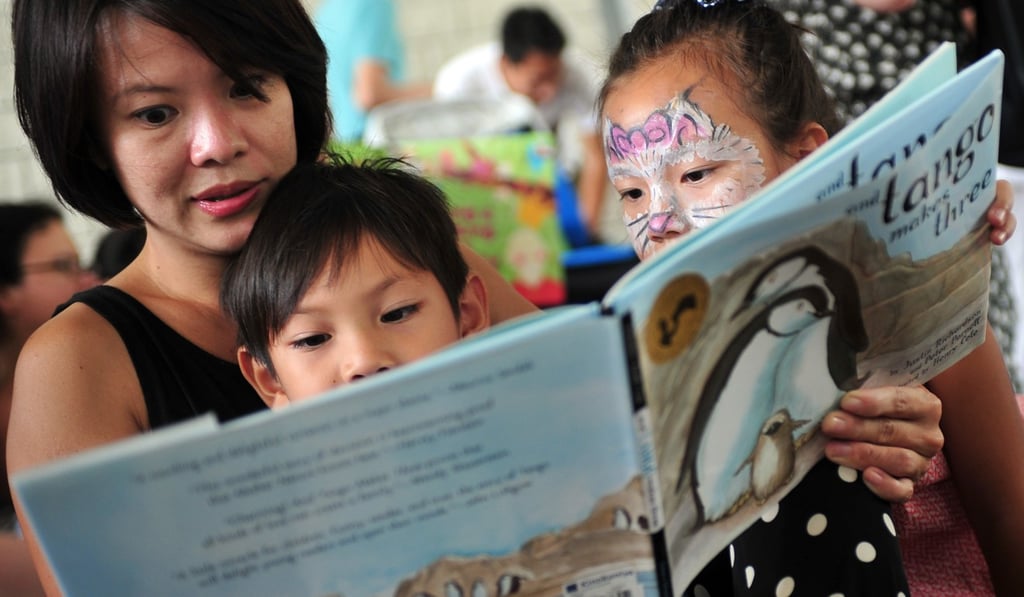 A woman reads to children outside the National Library building in Singapore. Photo: Xinhua