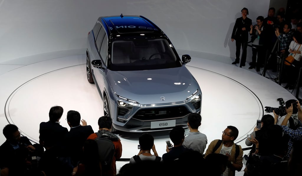 People gather at the booth of Chinese electric vehicle start-up Nio as it unveils its ES8 SUV at the Shanghai auto show on April 19, 2017. Photo: REUTERS