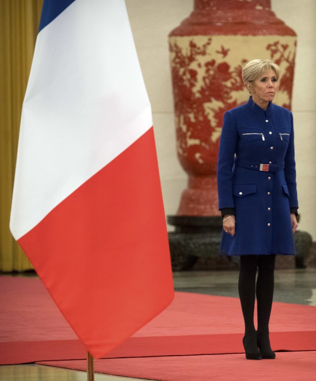 Brigitte Macron sports a coat dress in navy blue for a welcoming ceremony on Tuesday at the Great Hall of the People in Beijing. Photo: AP Brigitte Macron sports a coat dress in navy blue for a welcoming ceremony on Tuesday at the Great Hall of the People in Beijing. Photo: AP