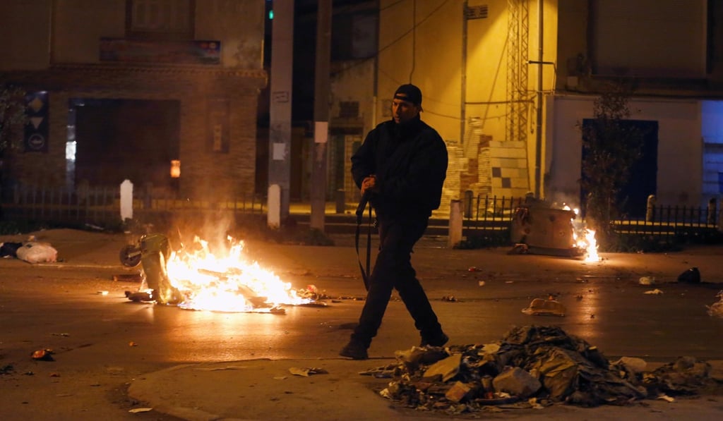 Riot police clash with protesters during demonstrations against rising prices and tax increases, in Tunis on Wednesday. Photo: Reuters