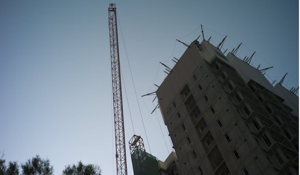 Construction continues in the So Uk public housing estate in Cheung Sha Wan. The estate is being redeveloped. Once completed, it will comprise 14 blocks, with nearly 7,000 flats. The government is aiming to produce 280,000 public rental and subsidised sales flats in the next 10 years, a target it will not meet if it does not find enough land for development. Photo: EPA-EFE