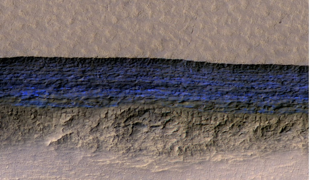 A cross-section of a thick sheet of underground ice is exposed at the steep slope that appears bright blue in this enhanced-colour view from a camera on Nasa’s Mars Reconnaissance Orbiter. Photo: Nasa/JPL-Caltech/UA/USGS