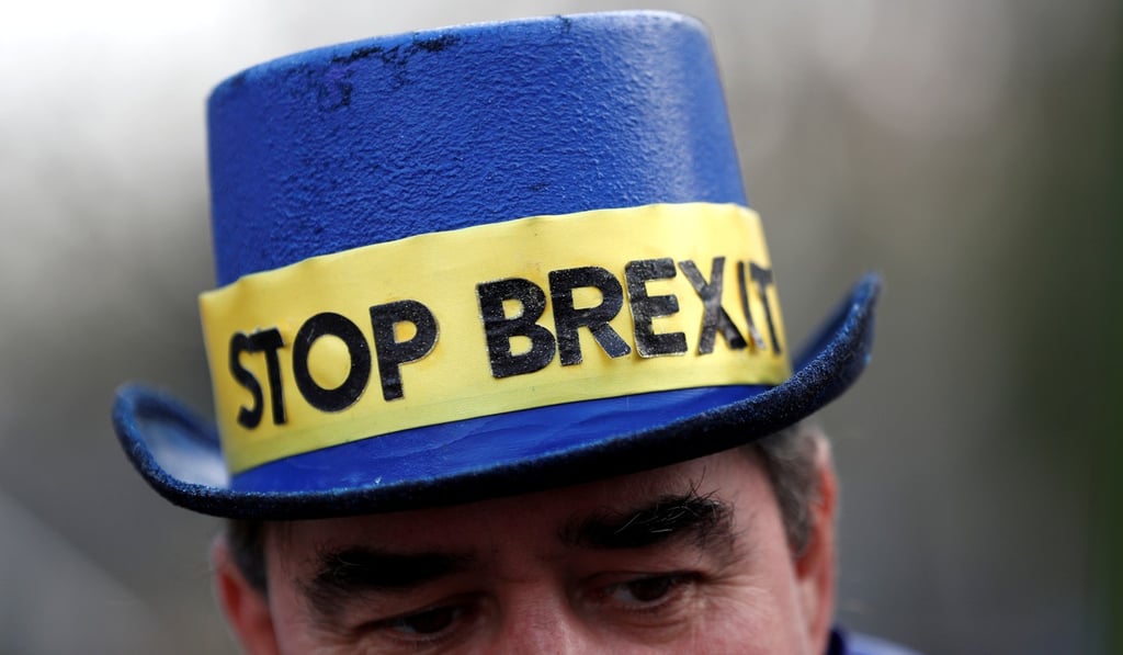 A protester wears a 'STOP BREXIT' hat outside the Palace of Westminster, London. Photo: Reuters