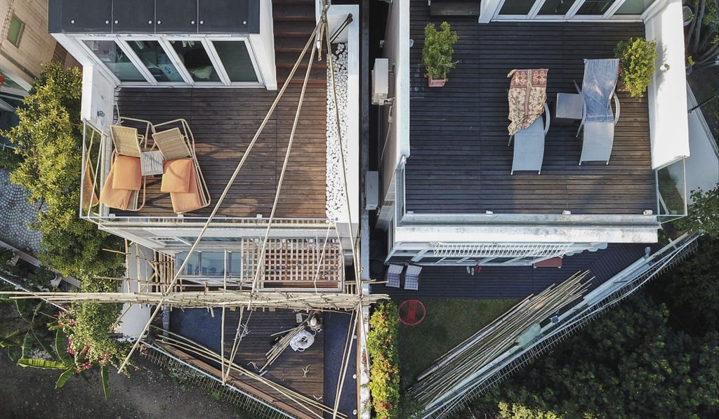 Workers set up scaffolding at Teresa Cheng’s home (left) in Siu Lam, Tuen Mun on Thursday. Photo: Winson Wong