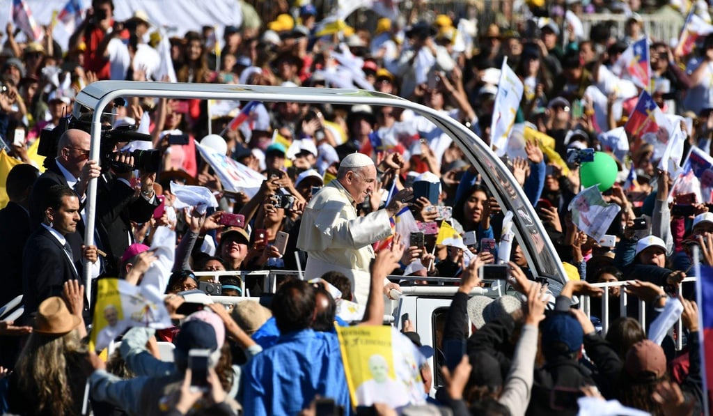 Pope Francis waves from the popemobile as he arrives at Maquehue airport in Temuco for an open-air mass. Photo: AFP