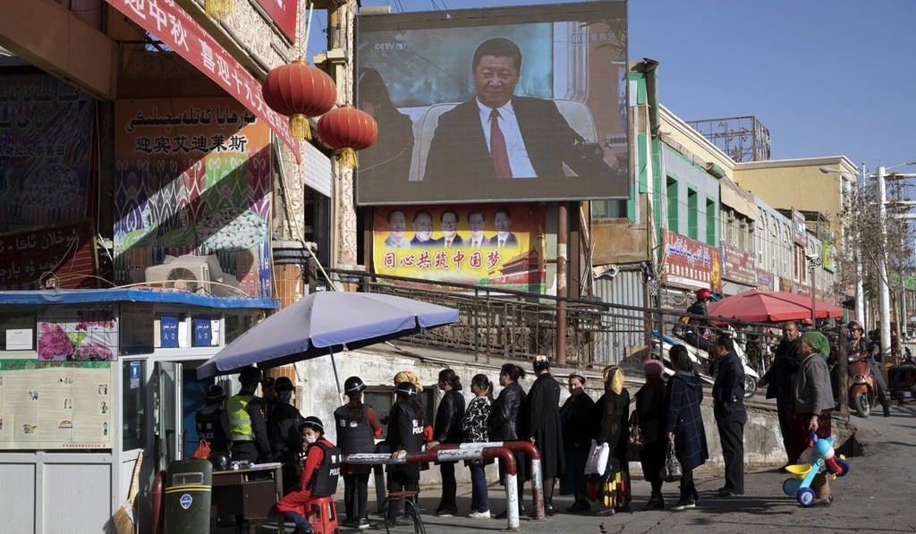 Residents walk through a security checkpoint at the Hotan Bazaar in Hotan, Xinjiang, in November last year. Photo: AP Residents walk through a security checkpoint at the Hotan Bazaar in Hotan, Xinjiang, in November last year. Photo: AP