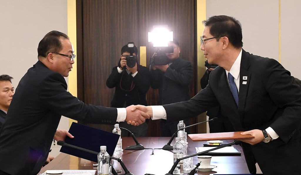 Chun Hae-sung (R, front), vice unification minister of South Korea, shakes hands with Jon Jong-su (L, front), vice-chairman of the Committee for the Peaceful Reunification of the Fatherland of the Democratic People's Republic of Korea (DPRK), at Peace House, a building in the South Korean side of Panmunjeom, on January 17, 2018. South Korea and the DPRK have agreed to jointly march at the opening ceremony of the South Korea-hosted Winter Olympics and to form a unified women’s ice hockey team. Photo: Xinhua Chun Hae-sung (R, front), vice unification minister of South Korea, shakes hands with Jon Jong-su (L, front), vice-chairman of the Committee for the Peaceful Reunification of the Fatherland of the Democratic People's Republic of Korea (DPRK), at Peace House, a building in the South Korean side of Panmunjeom, on January 17, 2018. South Korea and the DPRK have agreed to jointly march at the opening ceremony of the South Korea-hosted Winter Olympics and to form a unified women’s ice hockey team. Photo: Xinhua
