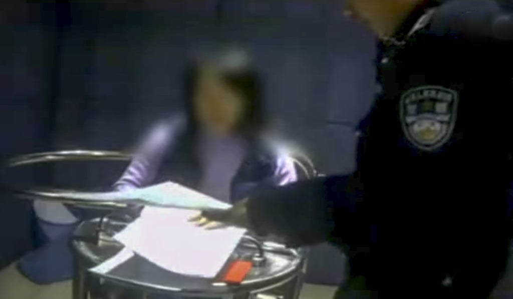 The woman pictured as she was questioned by police. Photo: Sohu.com