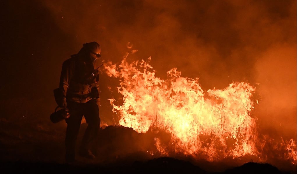 firefighters lighting backfires as they try to contain a wildfire in Ojai, California, last month. Fierce hurricanes, heatwaves, floods and wildfires ravaged the planet in 2017, as scientists said the role of climate change in causing or worsening certain natural disasters has grown increasingly clear. Photo: Agence France-Presse