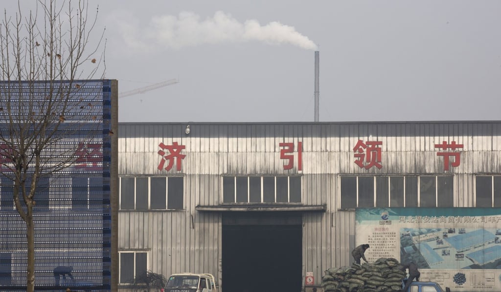 Workers load “clean coal” promoted by the government at a factory in Qianan in Hebei province. Across northern China, particularly in the poor countryside, residents still go to great lengths to acquire and burn coal for warmth despite government efforts to ban the practice and introduce cleaner – but costlier – types of coal or electric heating. Photo: AP