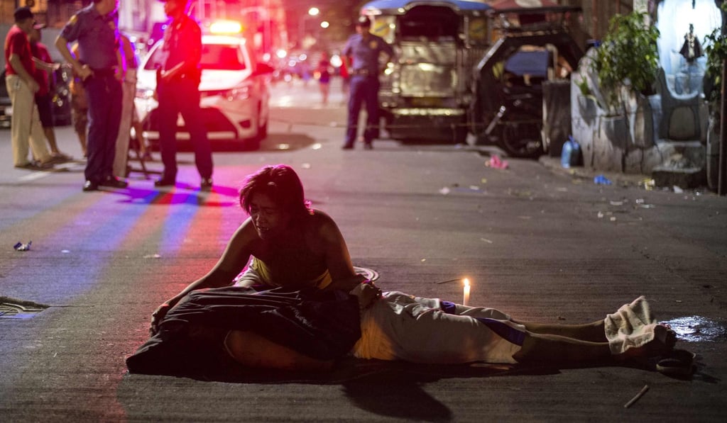 A mother grieves over the body of her dead son in Manila. The young man was a drug user, and a victim of President Rodrigo Duterte’s war on drugs. Photo: AFP