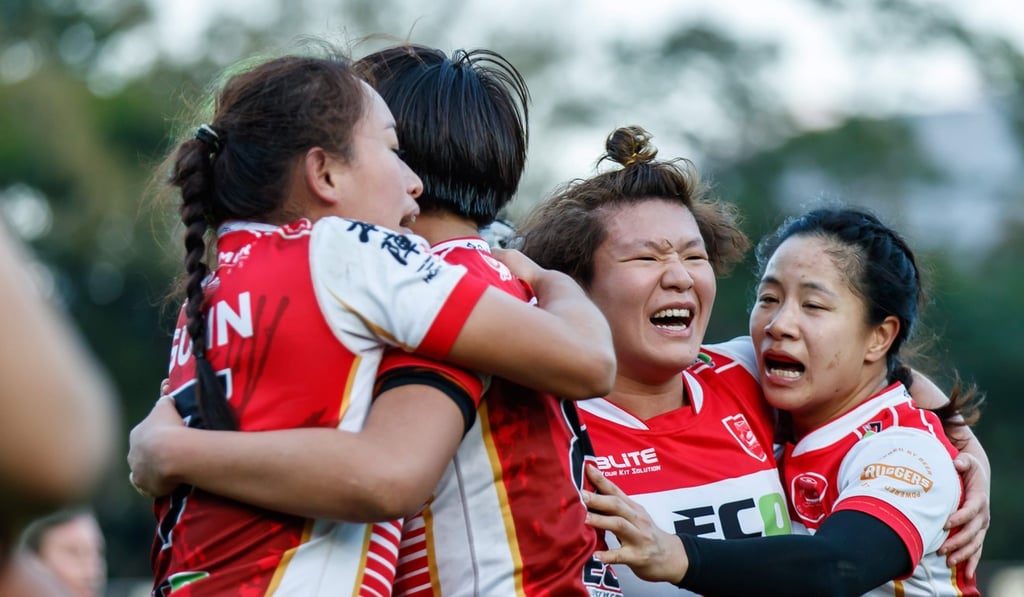 Christy Cheng (L) and her Gai Wu teammates celebrate their win over Valley.