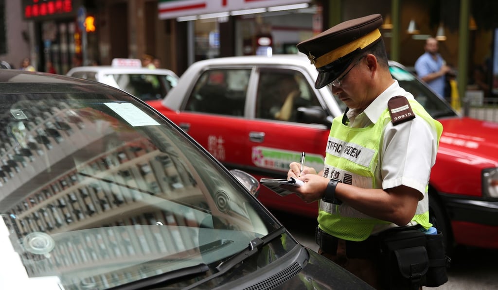 A traffic warden issues a ticket in North Point during a crackdown on illegal parking in September 2017. Photo: Sam Tsang