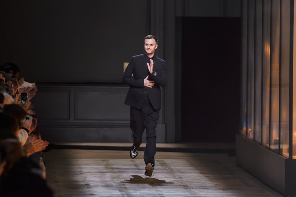 Belgian designer Kris Van Assche appears on the runway after the show. Photo: EPA