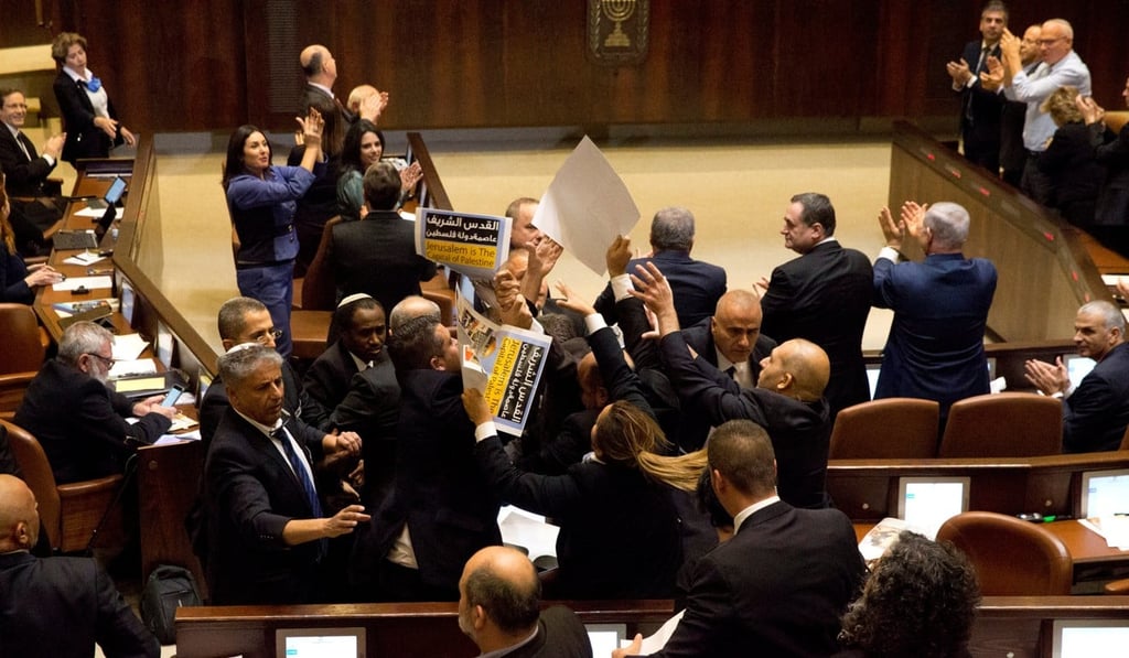 Ushers scuffle with members of the Joint Arab List who are protesting US Vice President Mike Pence’s address. Photo: Reuters