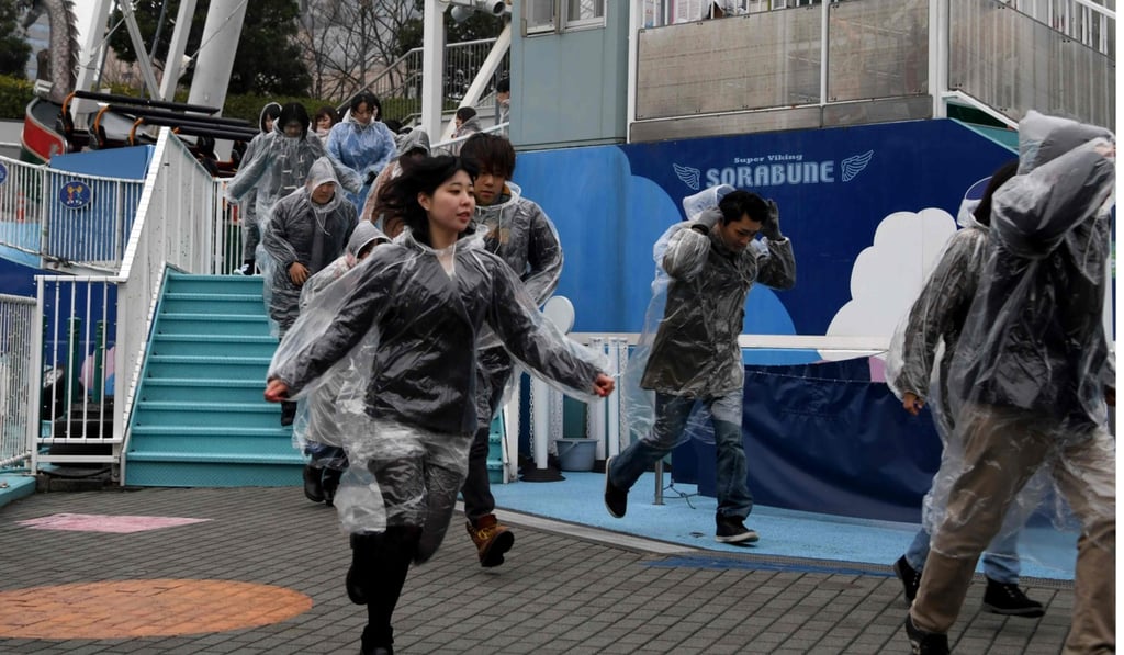 Amusement park visitors participate in the evacuation drill. Photo: AFP