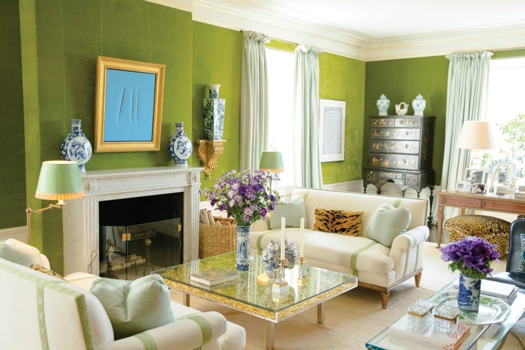 Vibrant green walls stand out against an otherwise neutral palette in Tory Burch’s living room.