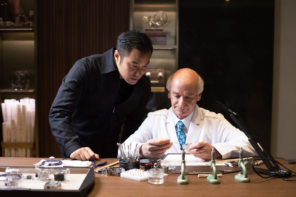 Joseph Chang watches with enthusiasm as an artisan demonstartes his watchmaking skills.