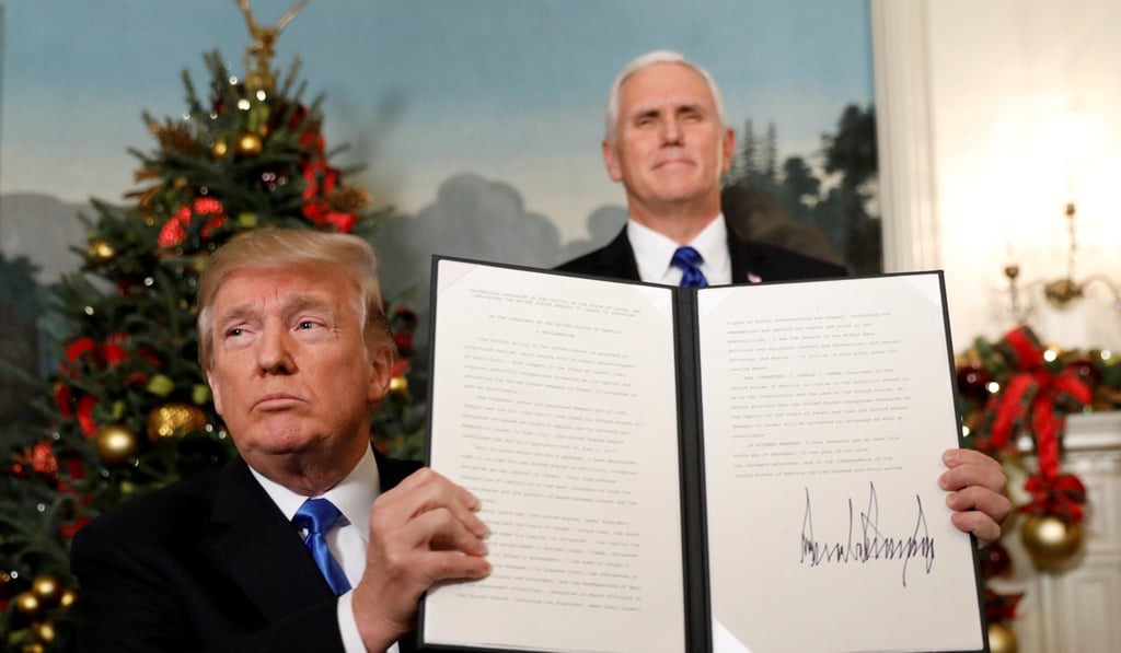 US Vice-President Mike Pence stands behind President Donald Trump after he signs the proclamation stating that the United States recognises Jerusalem as the capital of Israel. Photo: Reuters