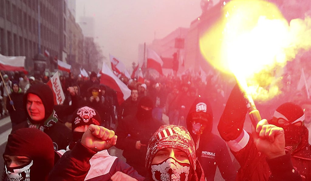 In this November 11, 2016 file photo, far-right nationalists burn flares as they march in large numbers through the streets of Warsaw to mark Poland's Independence Day. Poland's government is facing pressure to deal with the phenomenon of a rising far-right following the weekend broadcast of a report about Polish neo-Nazis. Photo: AP In this November 11, 2016 file photo, far-right nationalists burn flares as they march in large numbers through the streets of Warsaw to mark Poland's Independence Day. Poland's government is facing pressure to deal with the phenomenon of a rising far-right following the weekend broadcast of a report about Polish neo-Nazis. Photo: AP