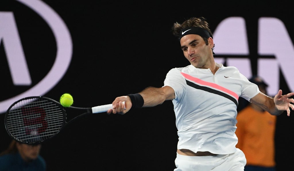 Roger Federer creams a return on his way to a crushing victory. Photo: AFP