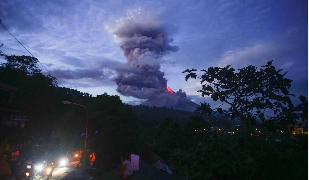 Residents watch as the Mayon volcano spews lava as it continues to erupt in Albay province, south of Manila. Photo: AFP