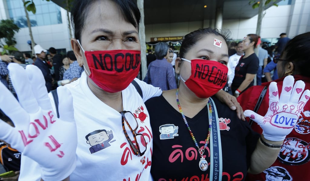 Supporters of exiled former Thai prime minister Yingluck Shinawatra display messages in support of her and opposition to the military junta in Bangkok in September. The protesters were rallying in front of the court which convicted Shinawatra in absentia for dereliction of duty in preventing misuse in the rice purchase scheme. Photo: EPA-EFE