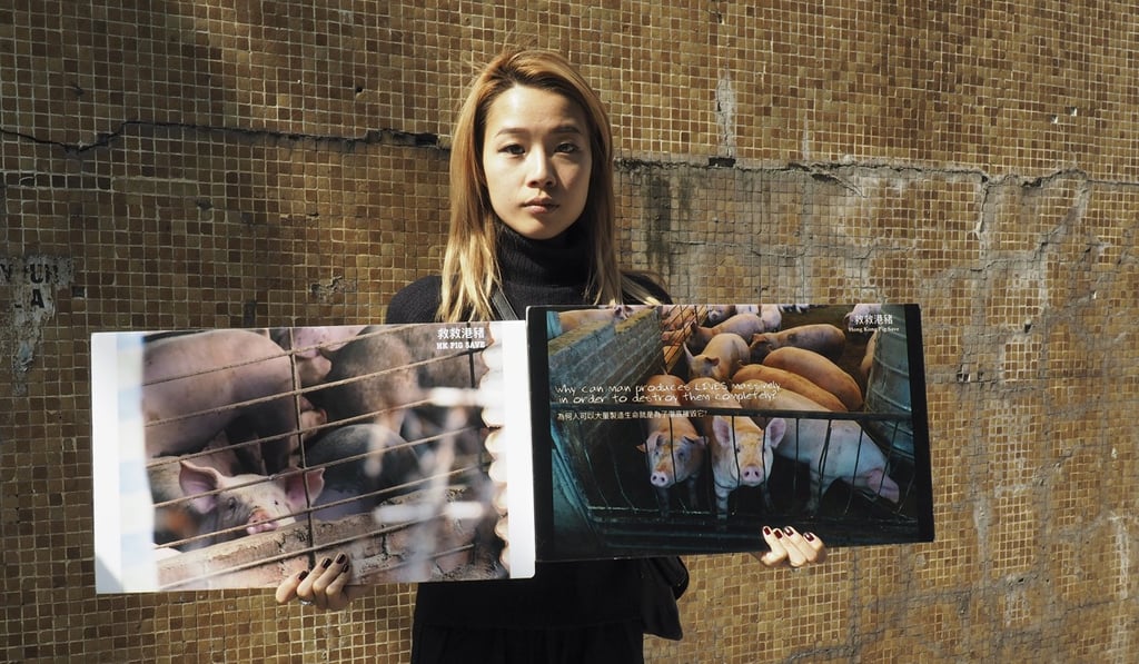 Vegan activist Nancy Lam holds a placard as members of Hong Kong Pig Save, a local vegan activist group, stage a protest at Tsuen Wan Abbatoir, accompanied by Australian celebrity activist Joey Carbstrong. Photo: Lauren James