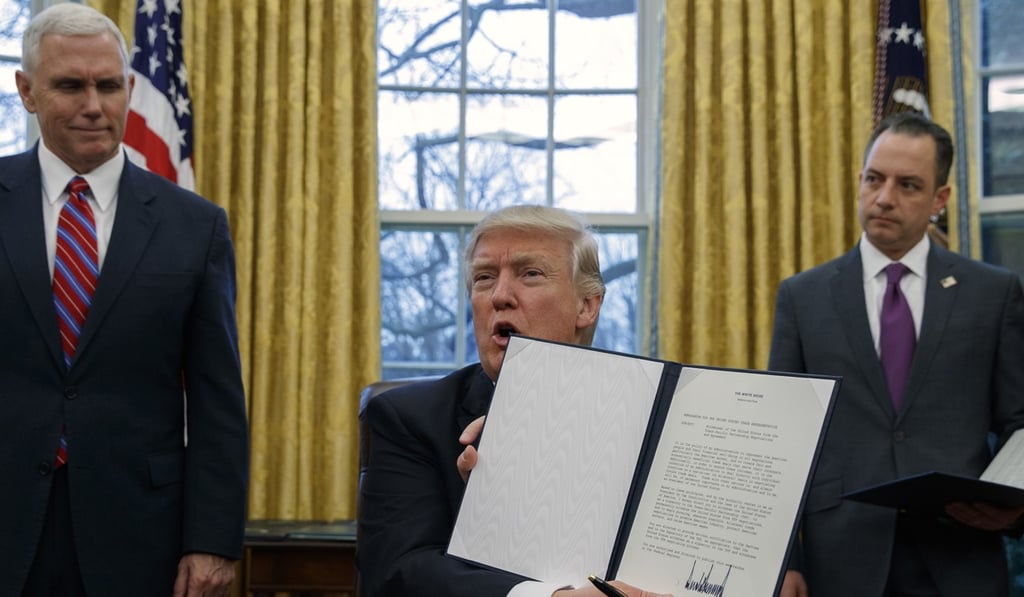 US President Donald Trump shows off an executive order to withdraw the US from the Trans-Pacific Partnership on January 23, 2017. Photo: AP