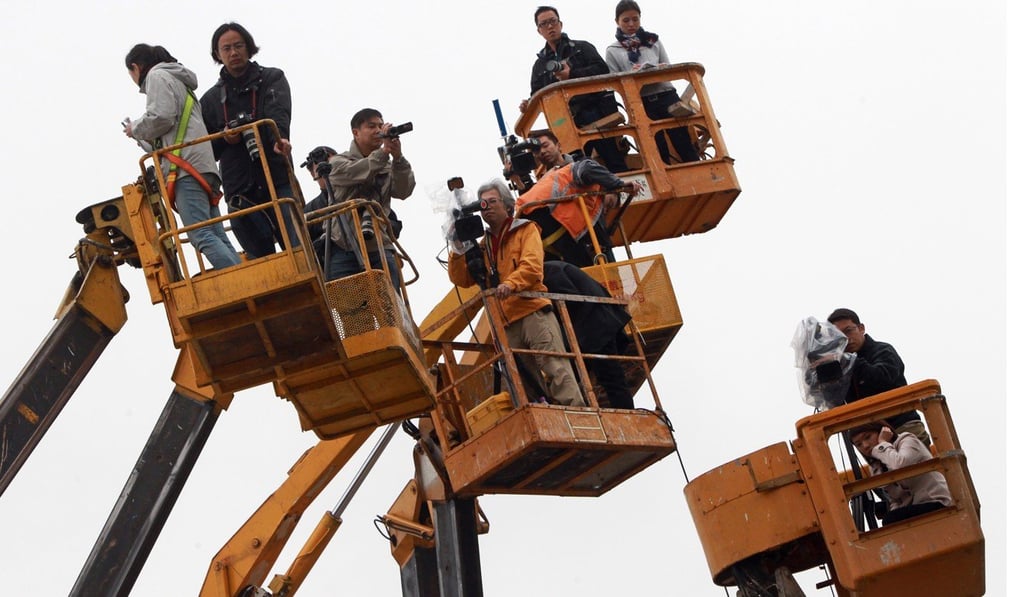 Reporters and photographers try to get a clear view of chief executive candidate Henry Tang’s house in Kowloon Tong, in February 2012, after it emerged that the property included an illegal basement. The scandal eventually scuttled Tang’s hopes of becoming Hong Kong’s leader. Photo: David Wong