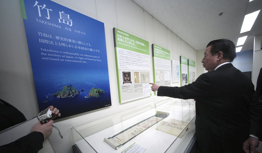 Tetsuma Esaki, minister in charge of territorial issues, inspects the new National Museum of Territory and Sovereignty in Tokyo on Thursday. Photo: AP