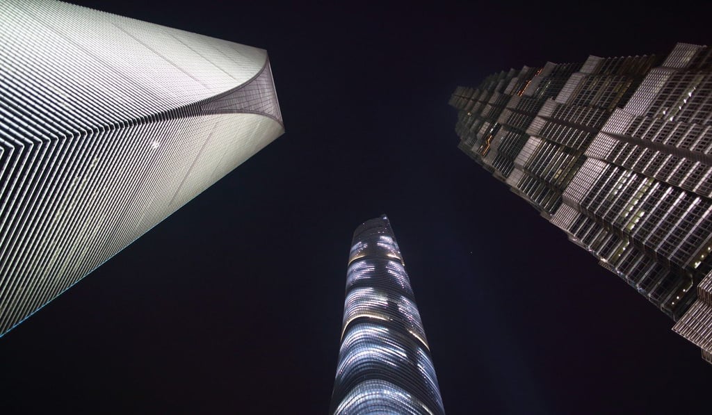 The Shanghai World Financial Center, left, the Shanghai Tower, centre, and the Jin Mao Tower stand illuminated at night in the Lujiazui district of Shanghai. Photo: Bloomberg