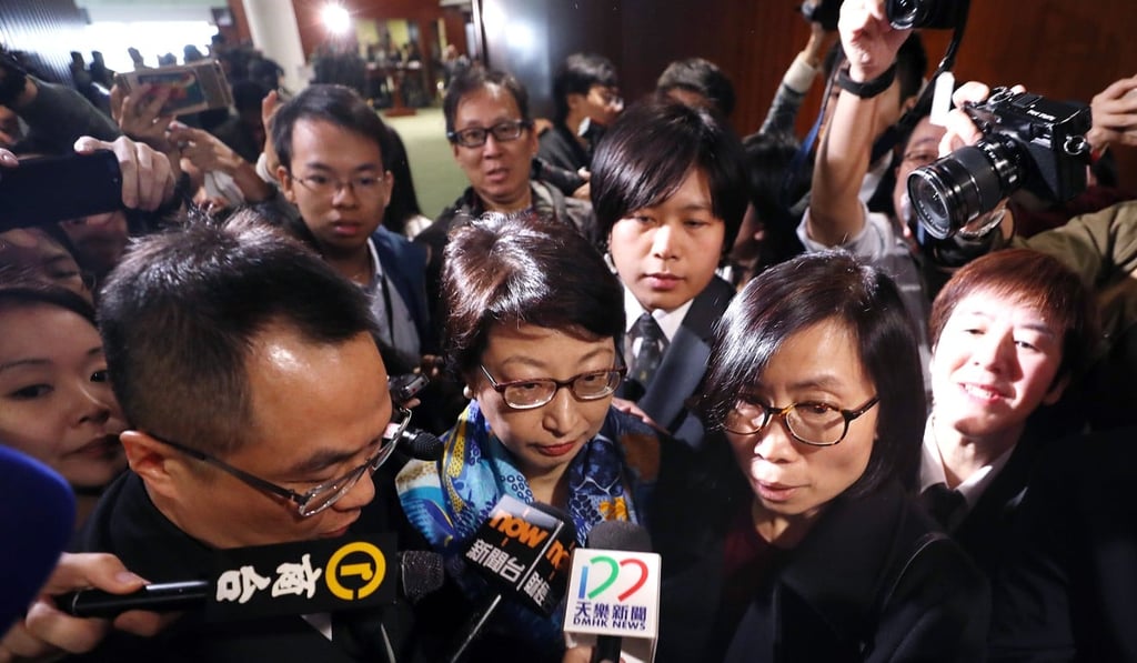 Cheng Yeuk-wah (centre) attending a Legislative Council meeting in Tamar on Wednesday, has faced calls to explain the illegal structures reported at her properties. Photo: Winson Wong