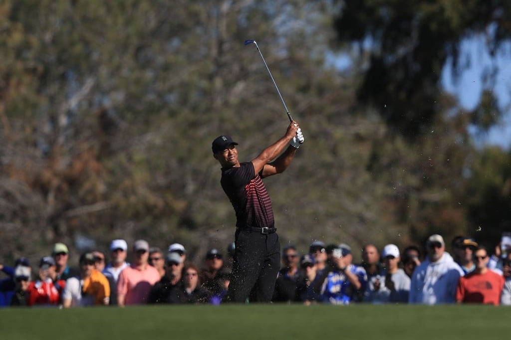Woods plays his second shot on the second fairway during the first round of the Farmers Insurance Open. Photo: AFP