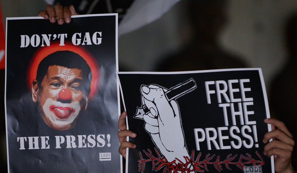 Journalists and supporters display placards showing President Rodrigo Duterte as a clown during a protest in favour of the freedom of press in Manila on January 19, 2018. Photo: AFP