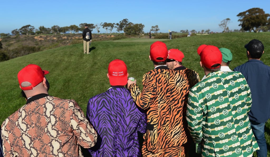 Fans watch Tiger Woods putt during his second round at the Farmers Insurance Open. Photo: AFP Fans watch Tiger Woods putt during his second round at the Farmers Insurance Open. Photo: AFP