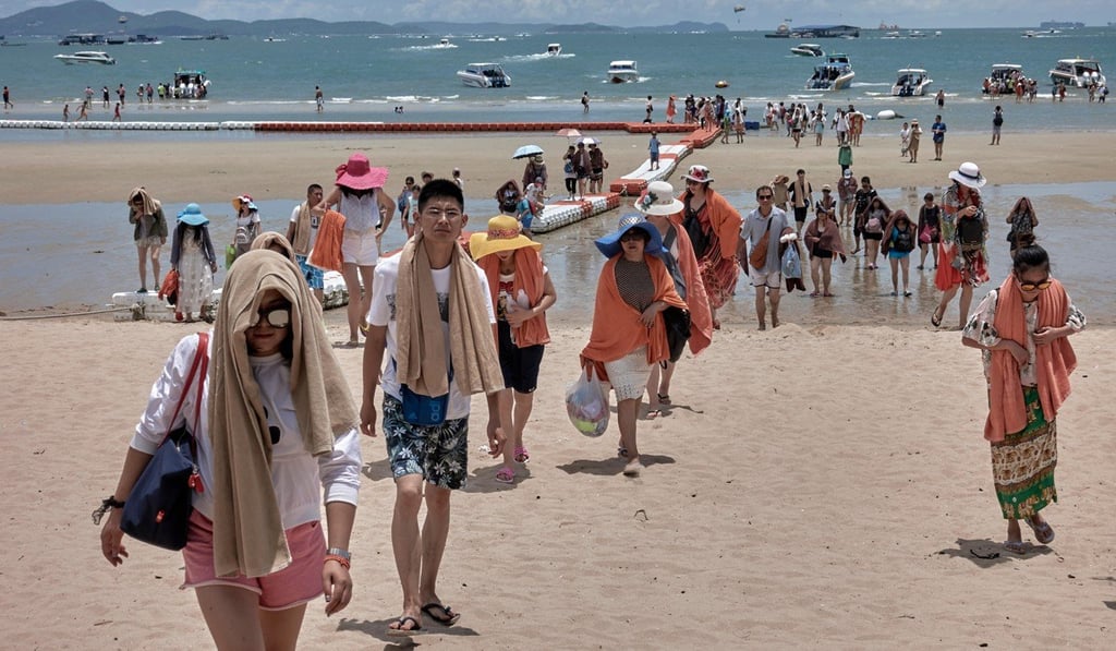 Large group of Chinese tourists returning from a boat trip in Pattaya, Thailand.