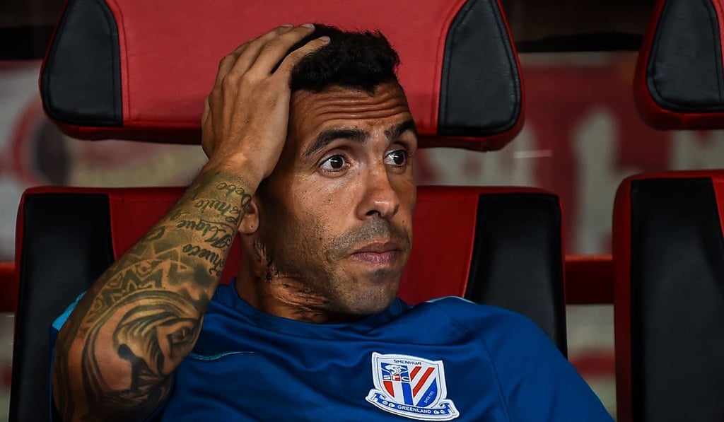 Argentine striker Carlos Tevez watches on from the Shanghai Shenhua bench. Photo: AFP