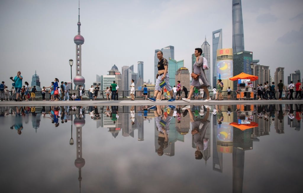 People walk on the Bund overlooking the financial district of Pudong in Shanghai. Central bank discipline chief Xu Jia’ai said there was a correlation between the growing risk in the sector and the weakening role of the party in financial affairs. Photo: AFP