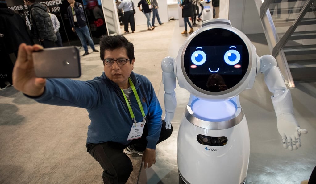 An attendee takes a selfie photograph with an Ubtech Robotics Cruzr robot during the 2018 Consumer Electronics Show (CES) in Las Vegas. Photo: Bloomberg