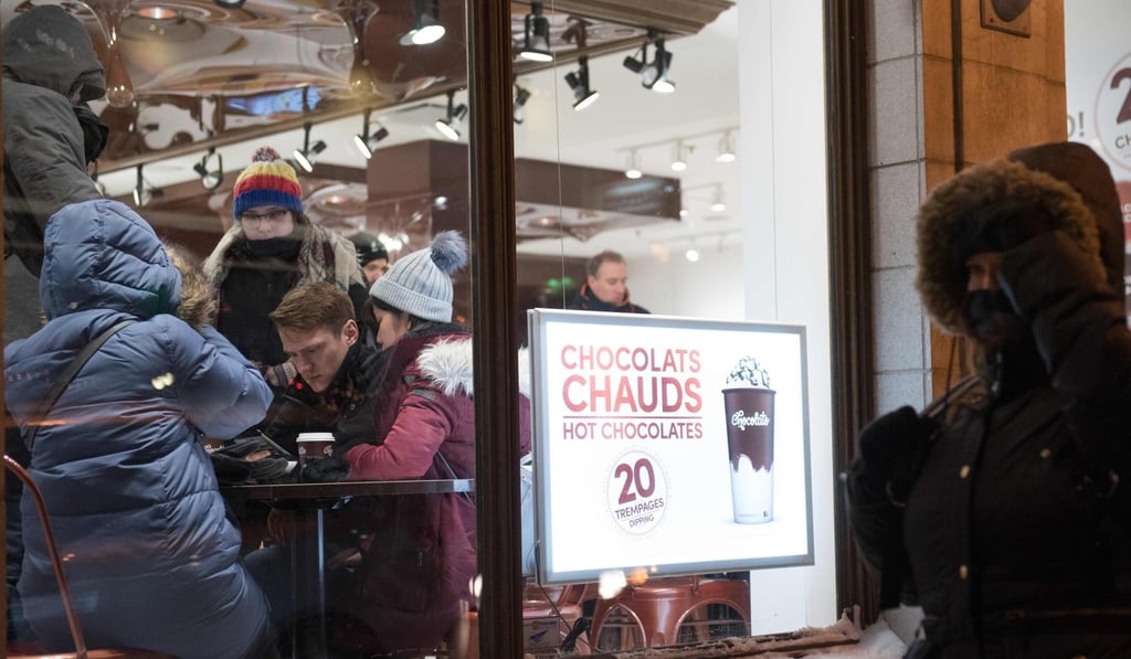 People gather at a shop selling hot chocolate in Quebec City, Canada, last December. Quebec passed a law making French the sole official language of the province to protect against the creeping influence of English. Photo: AFP
