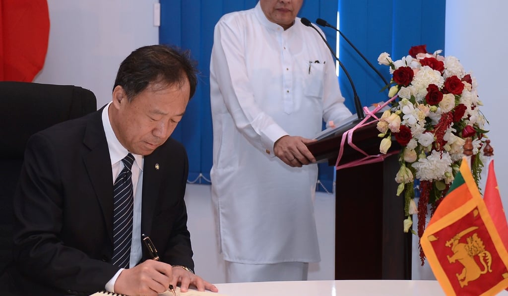 Managing Director of China Merchants Port Holdings Bai Jingtao signs a deal with the Sri Lankan government. Photo: AFP