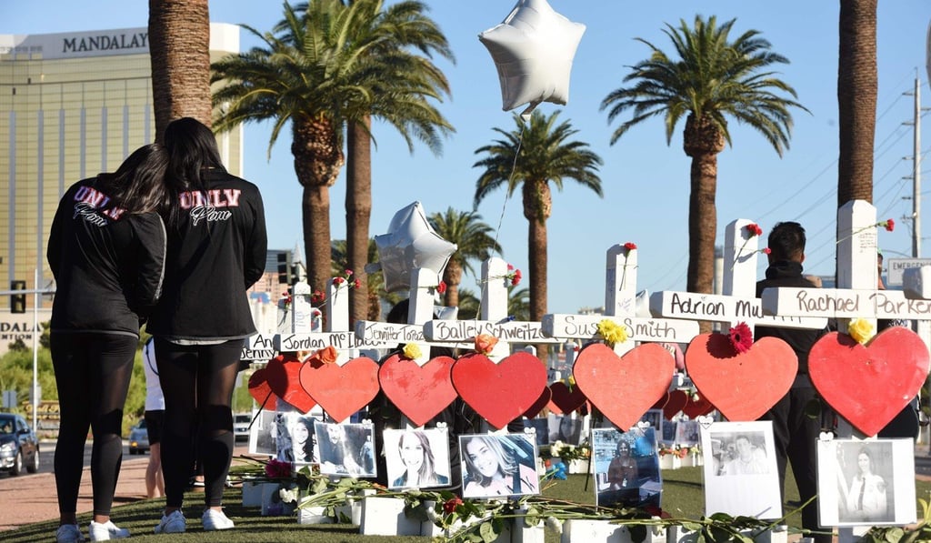 People visit 58 white crosses for the victims of the October 1 mass shooting on the Las Vegas strip. Photo: AFP